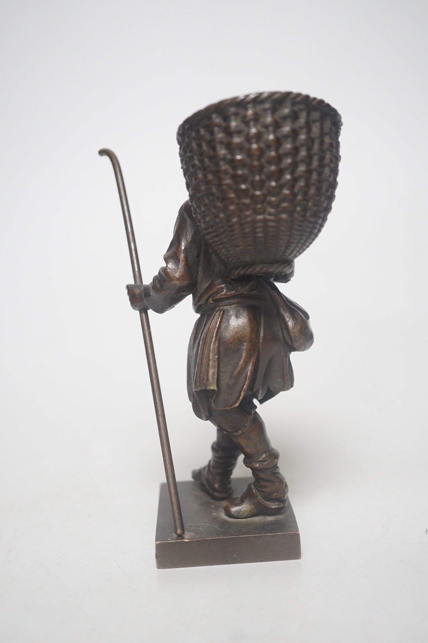 A 20th century bronze of a travelling salesman. 15cm tall